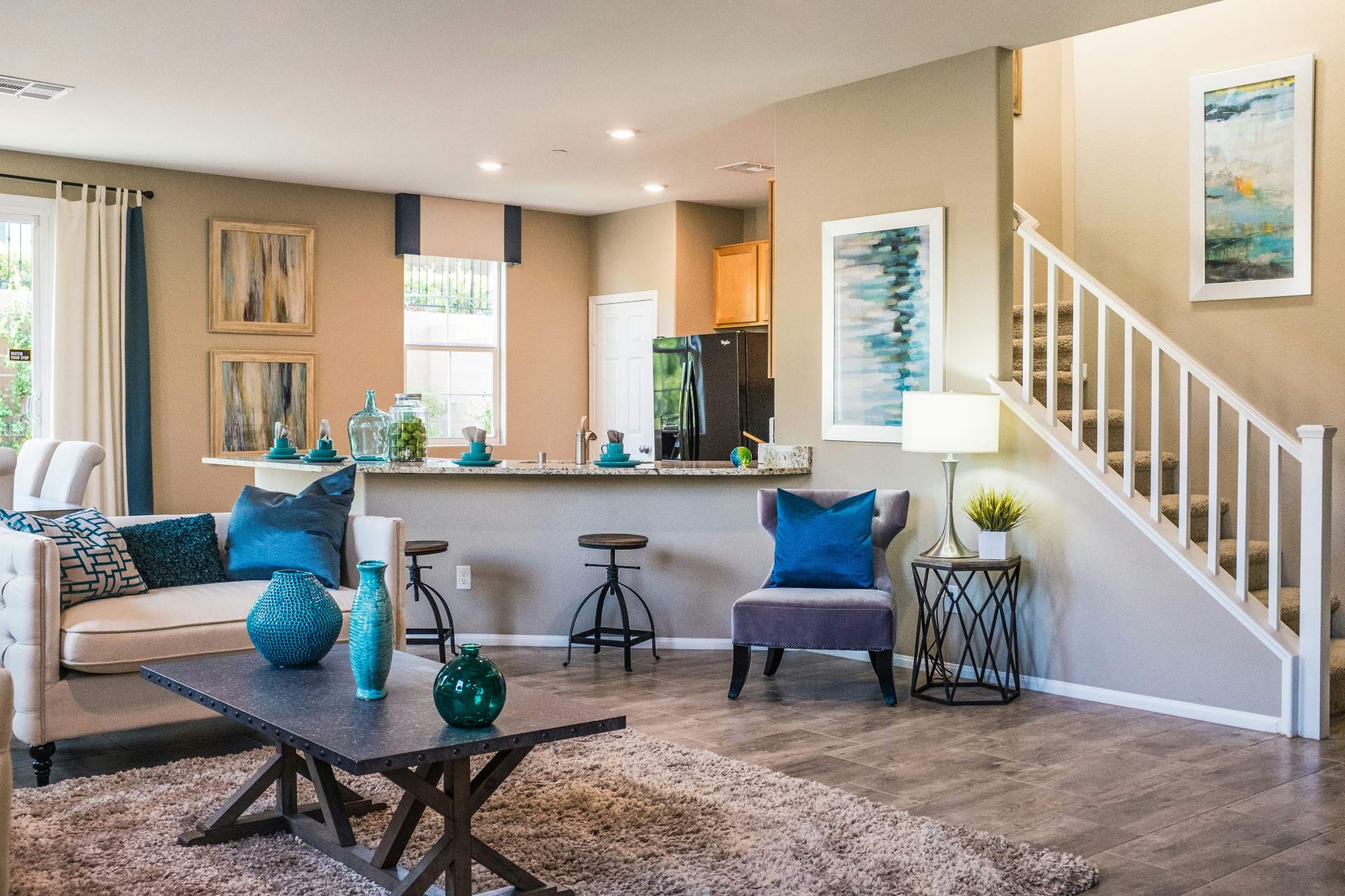 Modern, stylish living room with staircase.